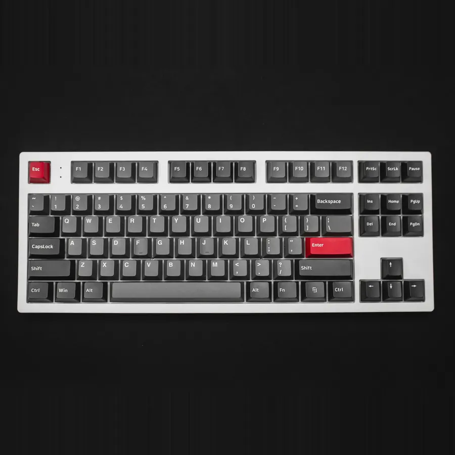 Teclado mecánico sin pad numérico, marco blanco y teclas grises con detalles rojos
